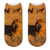 sock lion standing in front of a herd of game