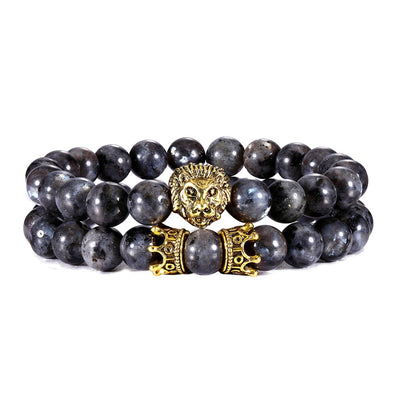bracelet of deep black glossy pearl with gold-plated lion head